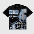 A black short-sleeve graphic t-shirt featuring a large, detailed black and white print on the front depicting a snowy night scene with a house, figures, and a large sign reading 'MYTH'.